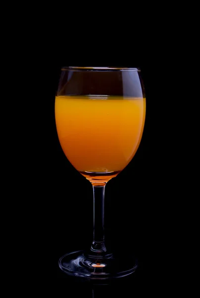 Still life of orange juice in glass on black — Stock Photo, Image
