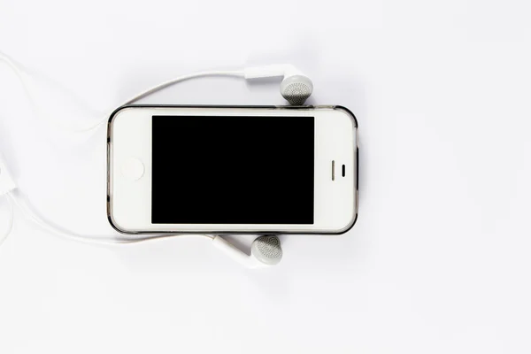 Mobiele telefoon met telefoon headsets — Stockfoto
