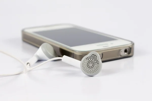 Cerrar auriculares telefónicos con teléfono móvil — Foto de Stock