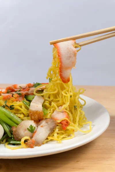 Pork dry noodles on wooden table — Stock Photo, Image