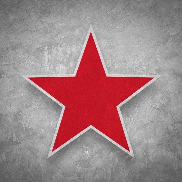 Красная звезда на гранжевом бетонном фоне — стоковое фото