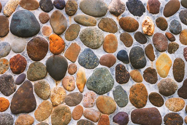 Pebble kamienia tekstura ściana i bezszwowe tło. — Zdjęcie stockowe