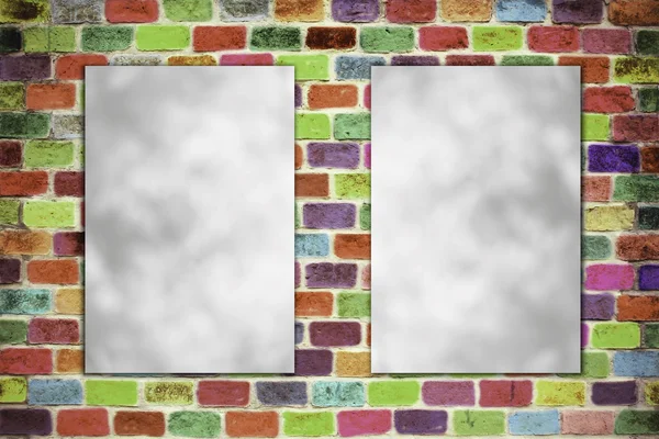 Blank folded paper poster hanging on colour brick wall — Stock Photo, Image