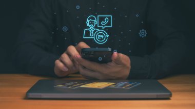 Sanal müşteri destek ikonlarına sahip akıllı telefon, 24 saat hizmet sembolü ve çağrı merkezi asistanı, çevrimiçi bankacılık, dijital ödeme, fintech desteği ve modern müşteri hizmetleri teknolojisi.
