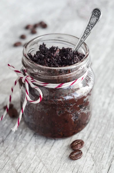 Coffee and cocoa (dark chocolate) homemade face and body scrub in a small glass jar — Stock Photo, Image
