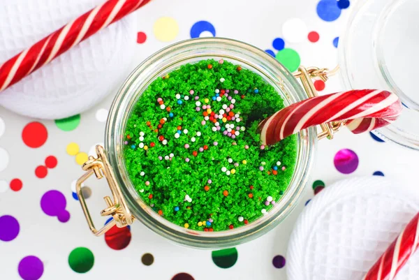 DIY green peppermint sugar scrub, aroma bath salts, foot soak in a glass jar. Homemade New Year gift. Christmas spa and beauty treatment. Selective focus, close up, copy space.