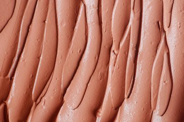 Terracotta kozmetik kil (aljinat yüz maskesi, yüz kremi, vücut ambalajı) dokusu yakın, seçici odaklanma. Fırça darbeleriyle soyut arkaplan. 