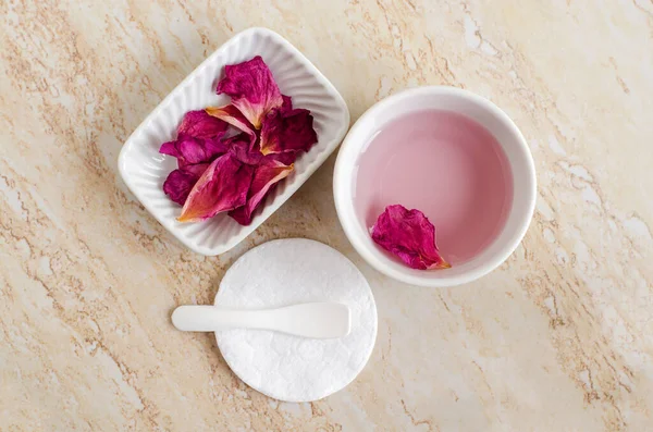 バラの水 トナー 乾燥したバラの花びらと綿のパッドを持つ2つの小さな白いボウル 自家製化粧品の原料 自然の美しさの治療レシピ ゼロ廃棄物の概念 トップビュー コピースペース — ストック写真