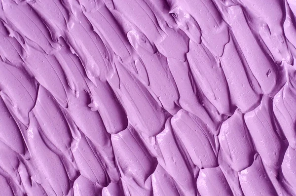 Purple clay (alginate face mask, body wrap, hair conditioner) texture close up, selective focus. Abstract lavender background with brush storkes.
