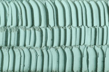 Gri, yeşil bentonit kil tozu (aljinat, yüz maskesi, göz farı, vücut ambalajı) dokusu yakın, seçici odaklanma. Soyut arkaplan. 