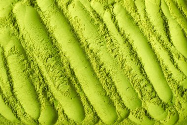 Kibrit tozu arka planı. Yeşil çay dokusu yakın, seçici odak