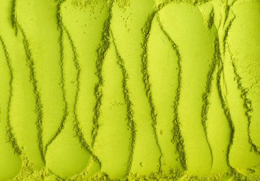 Kibrit tozu arka planı. Yeşil çay dokusu yakın, seçici odak