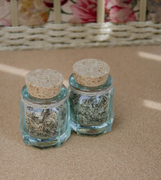 Two small bottles with dried herbs — Stock Photo, Image