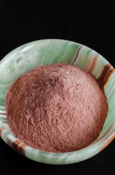 Red cosmetic clay powder in onyx bowl — Stock Photo, Image