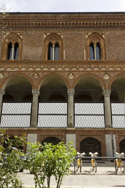 Historic facade of Milan Public University, with the bike sharing service Stock Photo