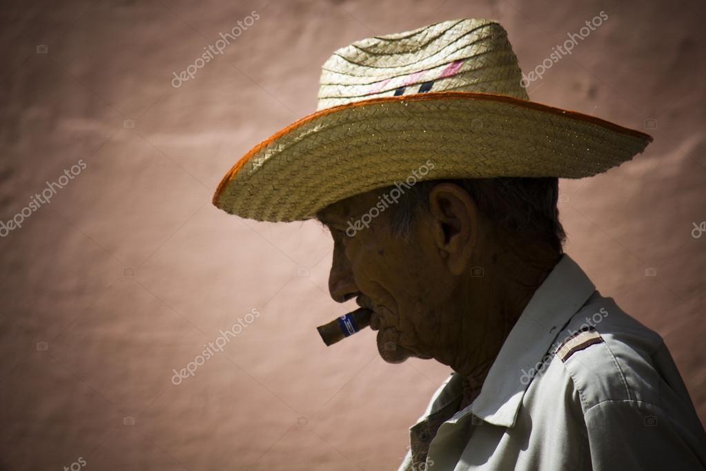 Old man smoking a cigar — Stock Editorial Photo © greta6 #52391591