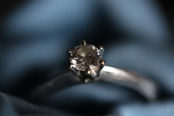 Engagement Ring on a blue textile — Stock Photo, Image