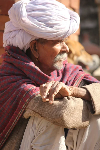 Homme indien âgé assis dans la rue — Photo