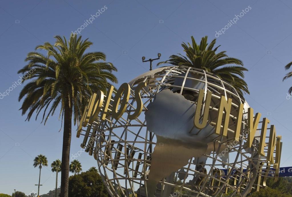 LOS ANGELES, CALIFORNIA - AUG 17 2013: Universal Studios Hollywood sign at the entrance of the amusement Park, suroounded by palms