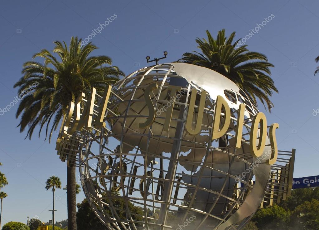 LOS ANGELES, CALIFORNIA - AUG 17 2013: Universal Studios Hollywood sign at the entrance of the amusement Park, suroounded by palms
