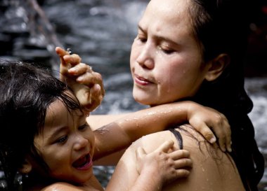 Mother and daughter bathing at Sacred Fountains