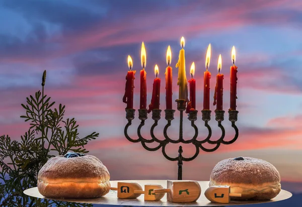 Burning Candles Menorah Festive Sweet Donates Wooden Plates Dreidels Hebrew — Stock Photo, Image