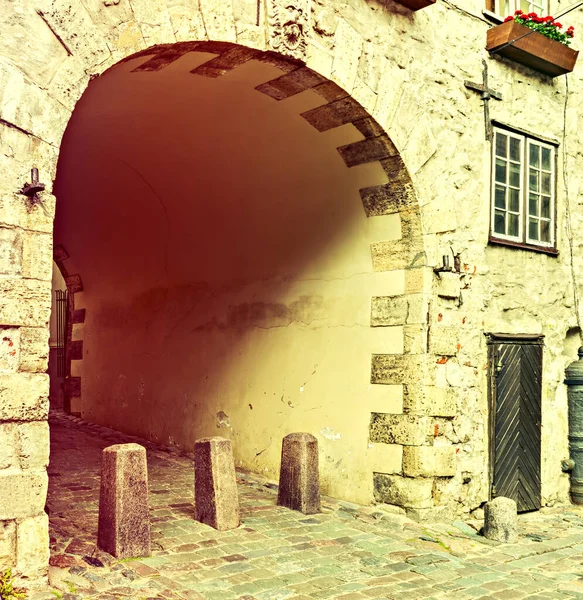 Medieval arch in old district of European town. For tourists, medieval architecture of such old towns can offer unforgettable unique atmosphere of the Middle Ages and Gothic architecture