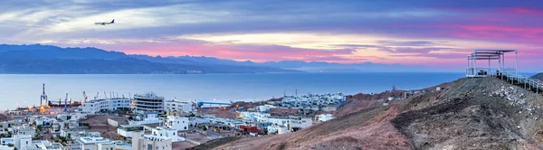 Panoramic nocturnal aerial scenic view on the Eilat (Israel) and Aqaba (Jordan) cities and northern shore of the Aqaba gulf, Red Sea