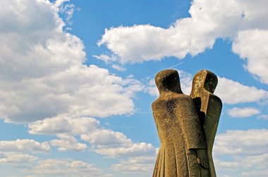 A stone sculpture of two people (or split personality) on the ba clipart