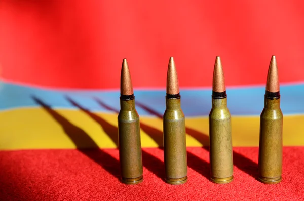 Bullets on a background Ukrainian flag (war in Ukraine, victims — Stock Photo, Image