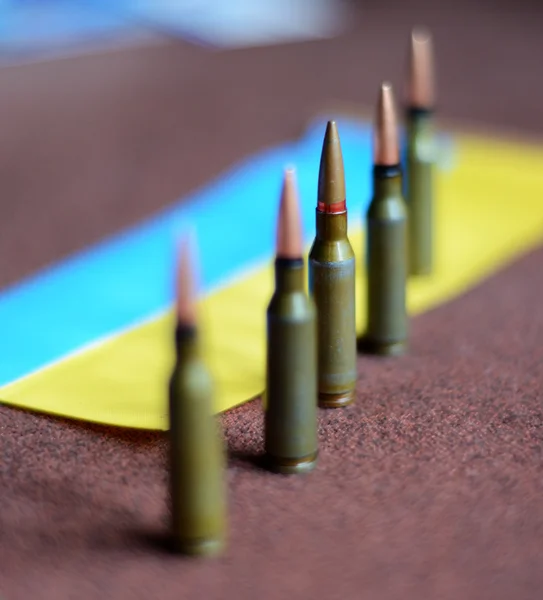 Bullets  on a background Ukrainian flag (war in Ukraine, victims — Stock Photo, Image