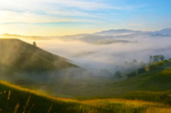 Fantástico paisaje en las montañas al amanecer con niebla. Respaldo — Foto de Stock