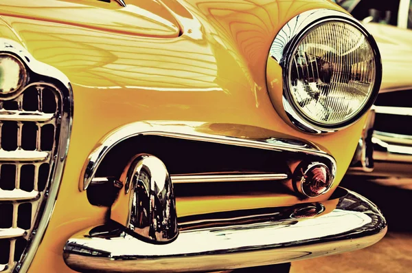 The hood, bumper, headlight and radiator of stylish yellow vinta — Stok fotoğraf