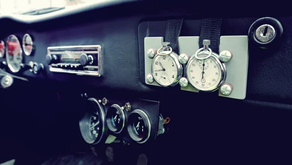 Beautiful original clock on the dashboard in vintage car. Vintag