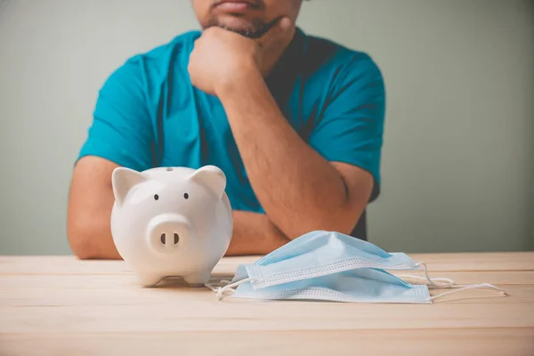 Een Witte Spaarpot Met Een Blauw Medisch Masker Een Houten — Stockfoto