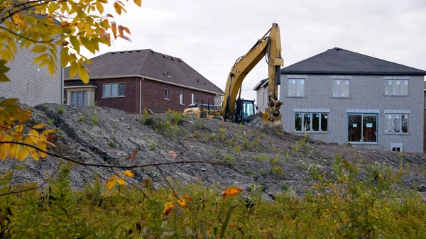 Excavator in a new housing construction site.