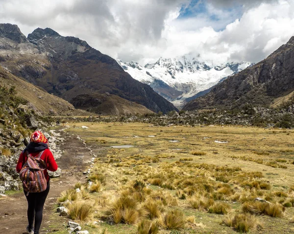 Vertical landscape of huge mountains with snow and ice and a blue lake with blue sky and clouds, in Huancayo, peru