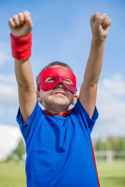 Superhero holding hands up and looking at the sun — Stock Photo, Image