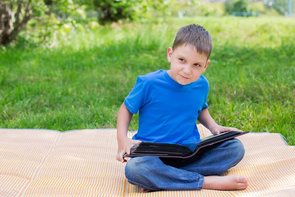 Boy sitting with opened album — Stock Photo, Image