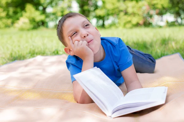 Boy thinking on the book with humour — Stock Photo, Image