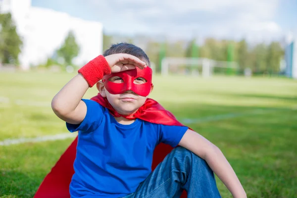 Superhero looking from under his hand — Stock Photo, Image