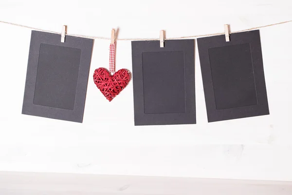 Cards and heart hanging on a rope hitched clothespins. — Stock Photo, Image
