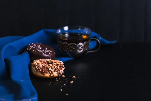 Donuts with different powder on a black wooden background — Stock Photo, Image