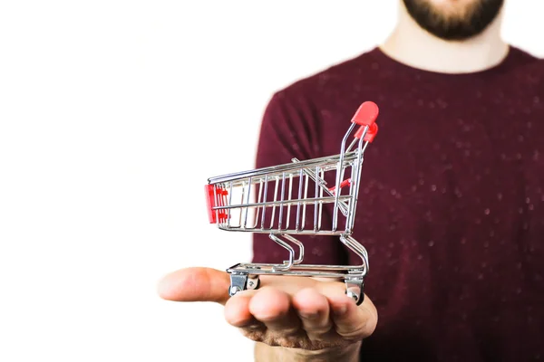 Carrinho de compras na mão sobre fundo branco — Fotografia de Stock