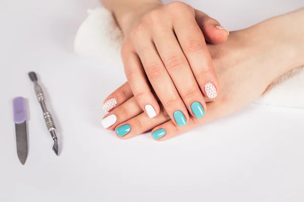 beautiful manicure. gel polish coating in white and turquoise, stamping.