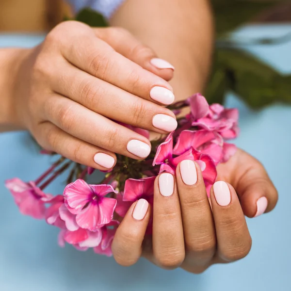 Mooie vrouw met mooie roze manicure nagels — Stockfoto