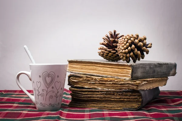 Cup of coffee and book on table with checkered tablecloth — Stock Photo, Image