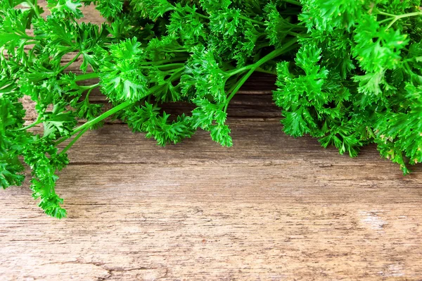 Tied fresh parsley on wooden surface — Stock Photo, Image