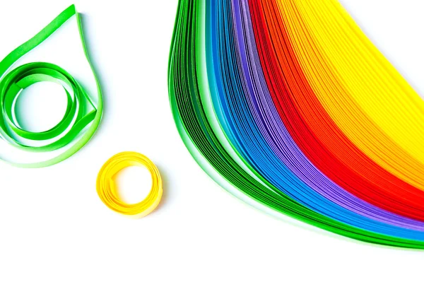 Rainbow colored quilling paper laid out in waves and shapes — Stock Photo, Image