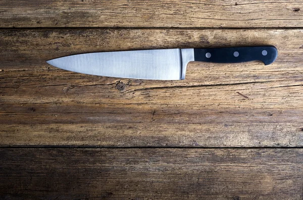 Knife on rustic kitchen table with copy space — Stock Photo, Image